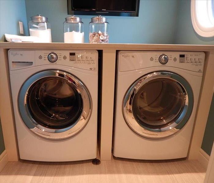 Washing Machine and dryer under a counter in a laundry room